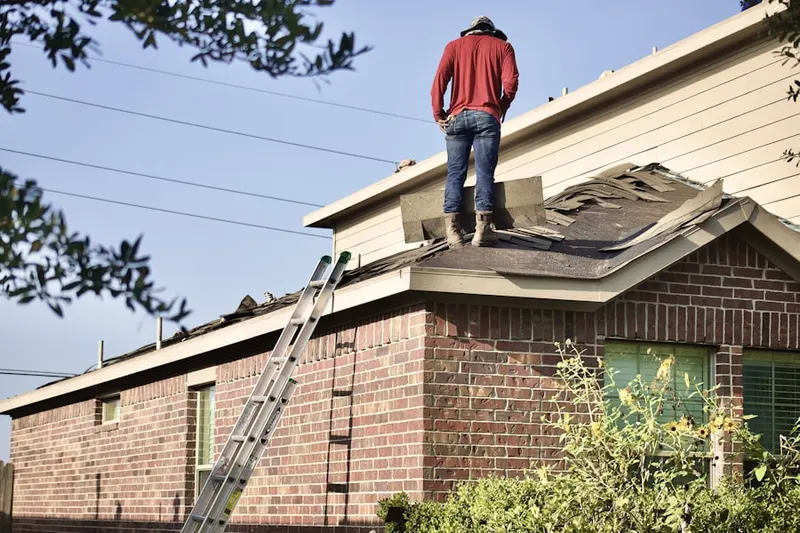 Professional roofer working on a residential roof in Michigan Bluff